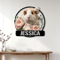 Floral guinea pig metal wall sign displayed on a bright paneled wall above a console table