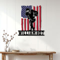 Patriotic football metal sign displayed on a white paneled wall above a wood console table