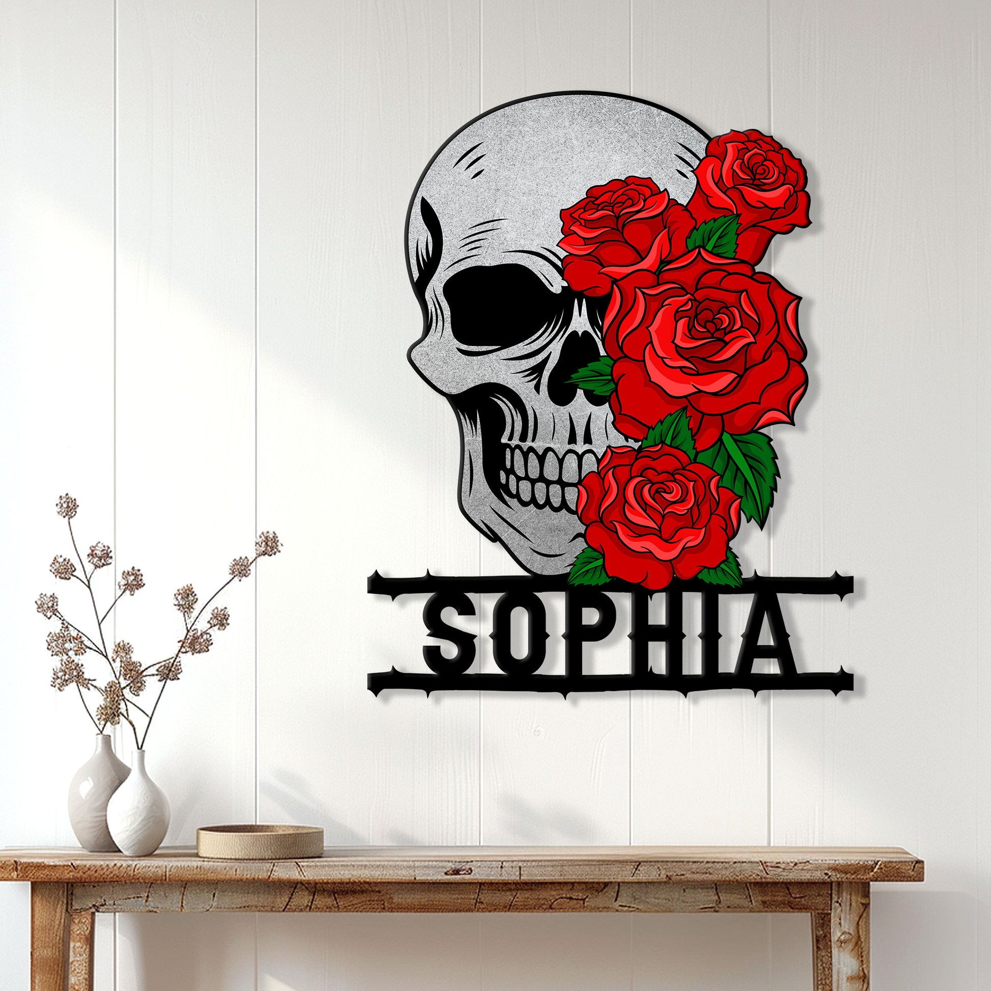 Skull and roses metal wall sign displayed on a light wood-paneled wall above a console table