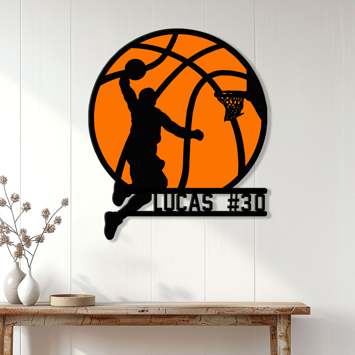 Basketball metal wall sign displayed on a white paneled wall above a wood console