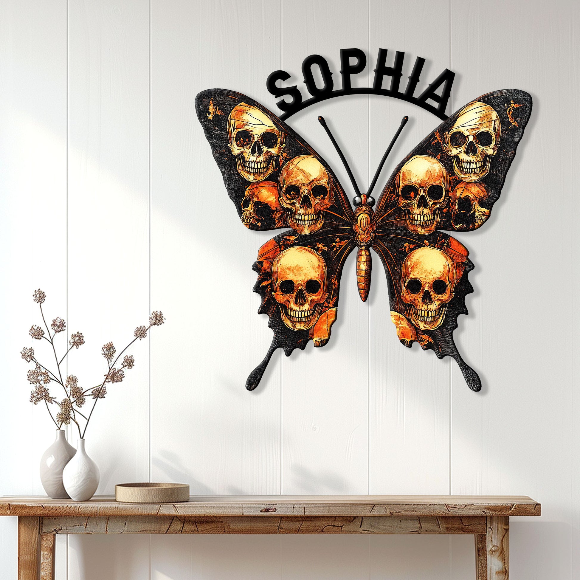Skull butterfly metal wall sign displayed on a light wood-paneled wall above a console table