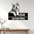 Husky house sign displayed on a light paneled wall above a wooden console table in a modern entryway