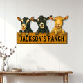 Goat metal sign displayed on a light paneled wall above a rustic console table
