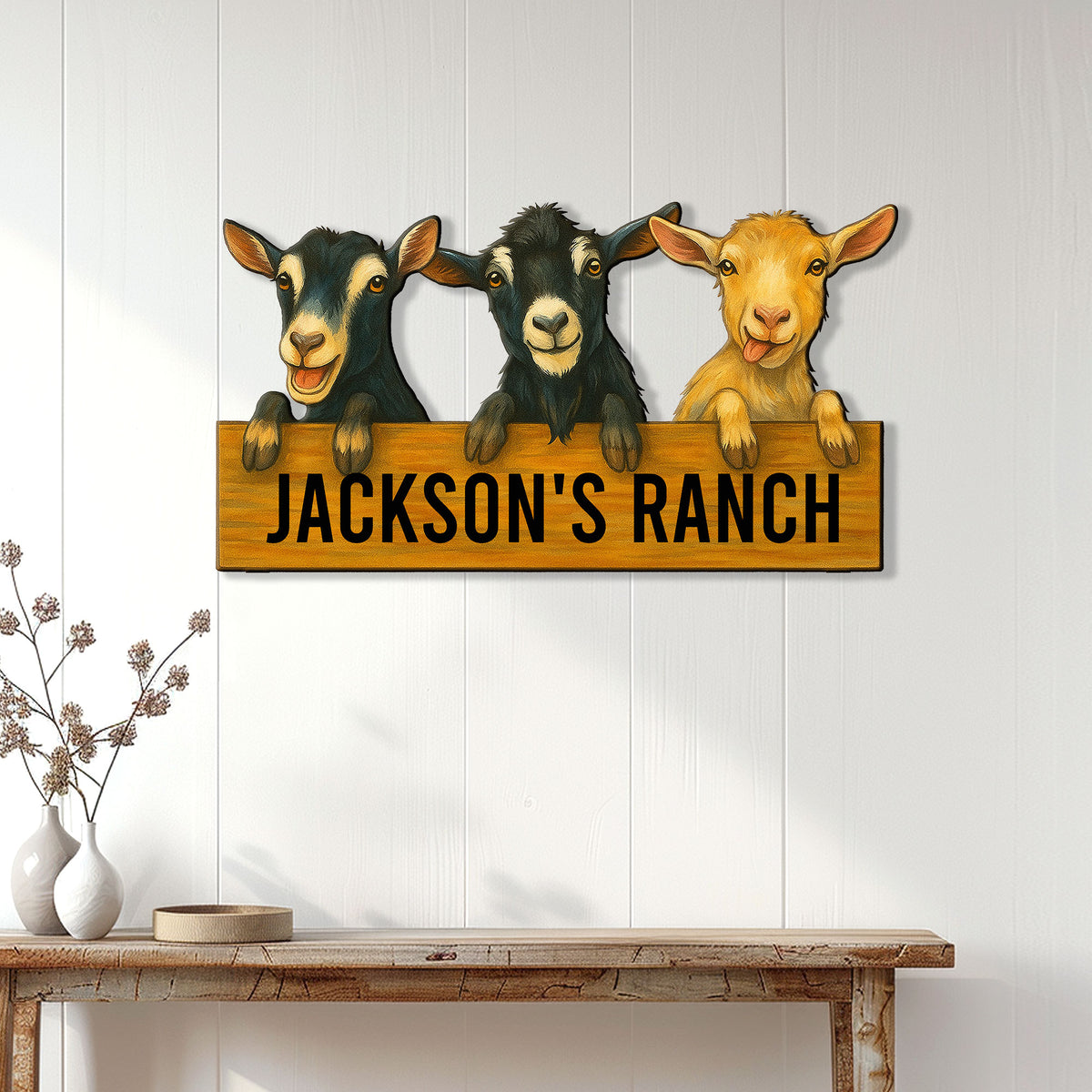 Goat metal sign displayed on a light paneled wall above a rustic console table
