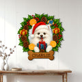 Pomeranian Christmas wall sign displayed on a bright paneled wall above a rustic console table