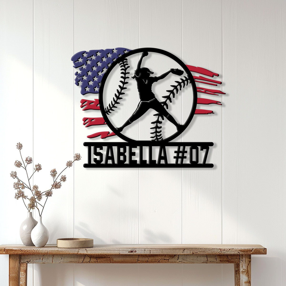 Softball player metal wall sign displayed on a white paneled wall above a wood console table