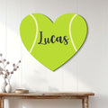 Heart-shaped tennis ball sign displayed as colorful wall decor in a bright home interior