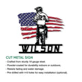 Cut metal motocross sign featuring a helmeted racer silhouette over a distressed American flag