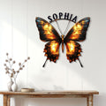 Butterfly metal wall sign displayed above a console table in a bright modern home