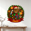 Maine Coon holiday metal wall sign displayed on a white paneled wall above a console table