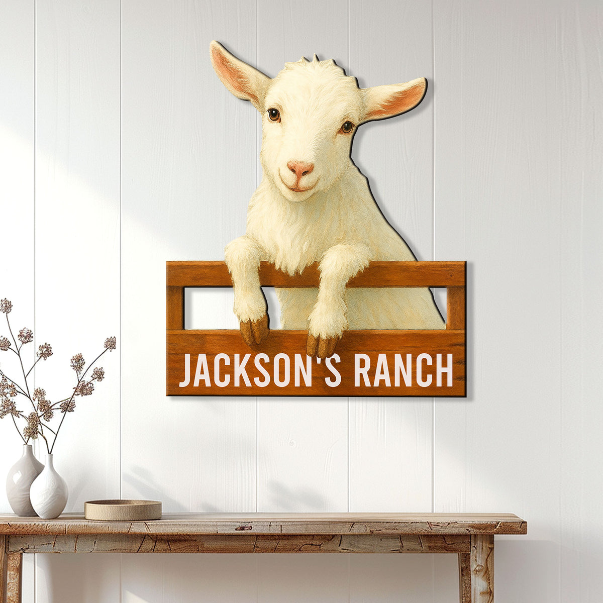 Goat ranch wall sign displayed on white farmhouse paneling above a rustic console table