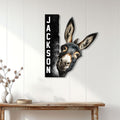 Donkey wall sign displayed on white paneled decor above a rustic console table