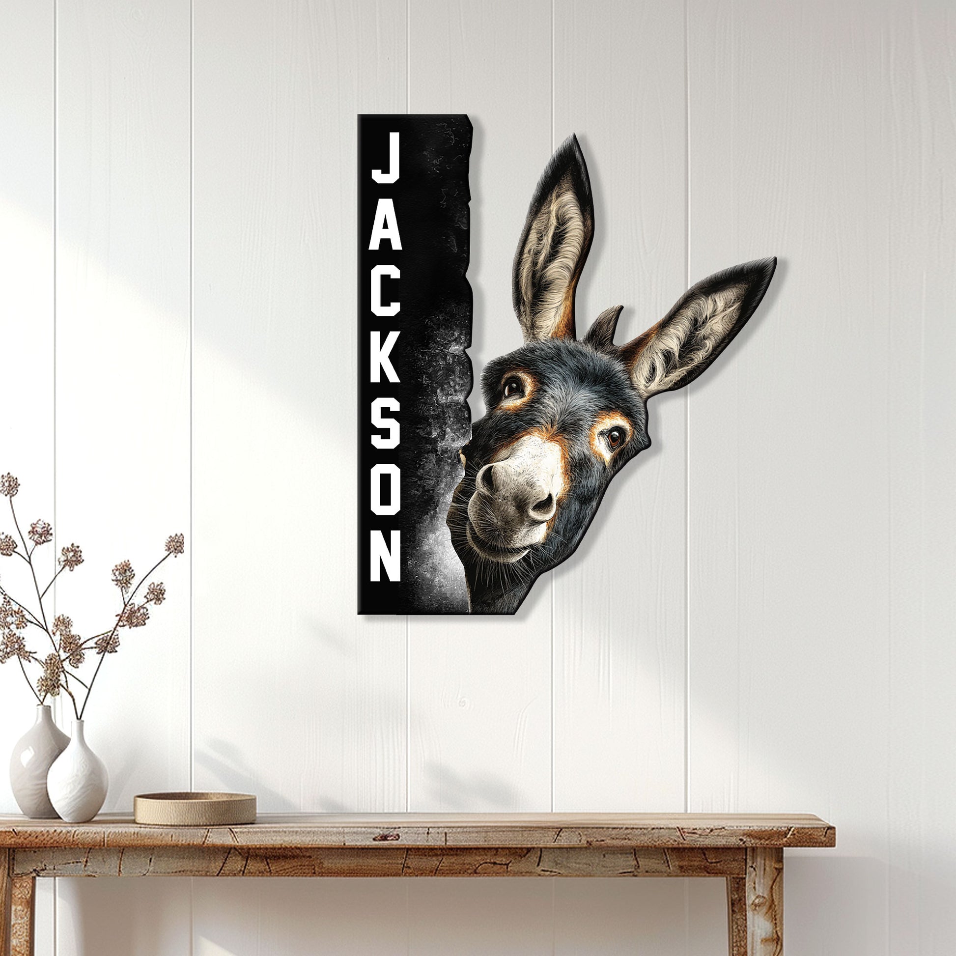 Donkey wall sign displayed on white paneled decor above a rustic console table