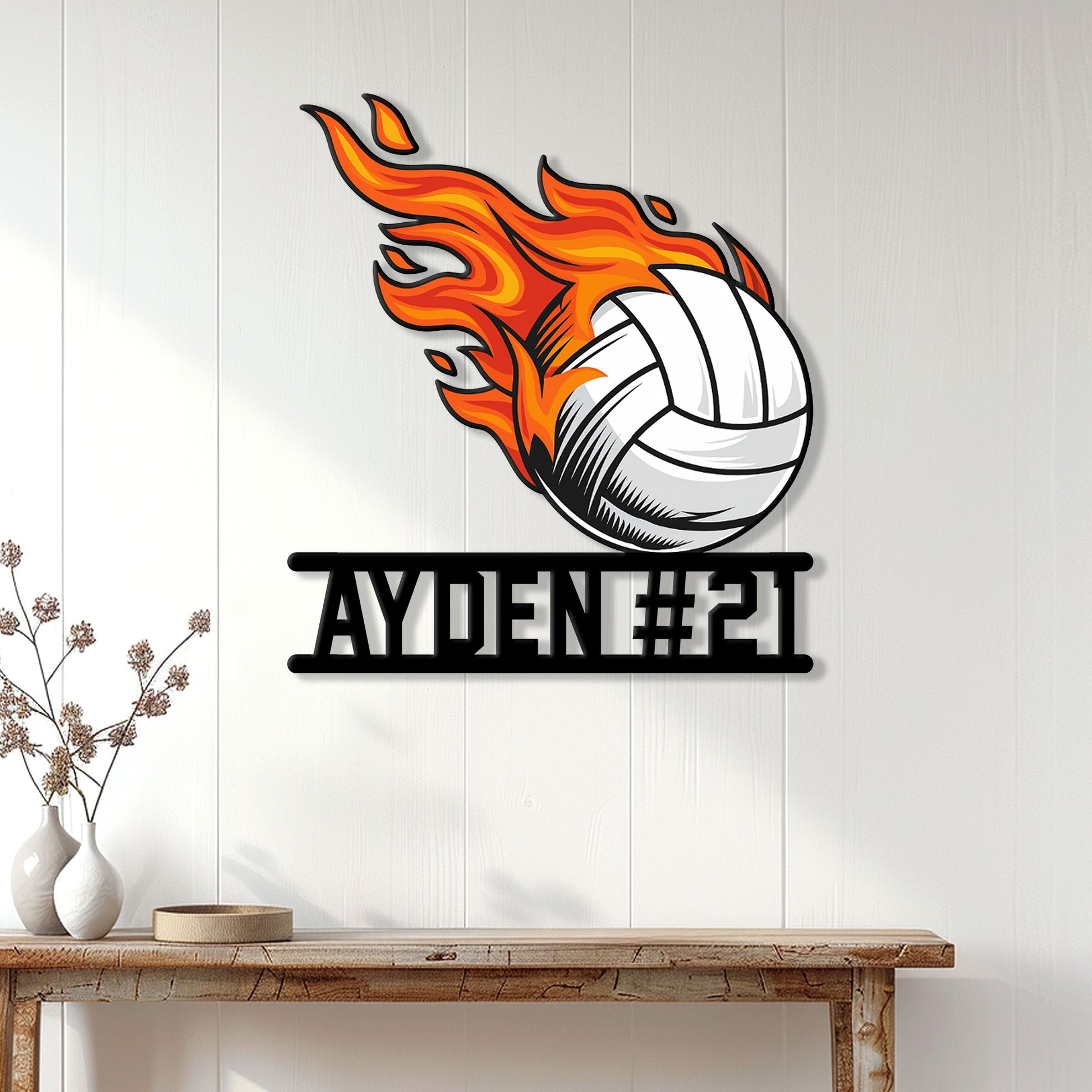 Flaming volleyball wall sign displayed on a bright paneled wall above a wooden console