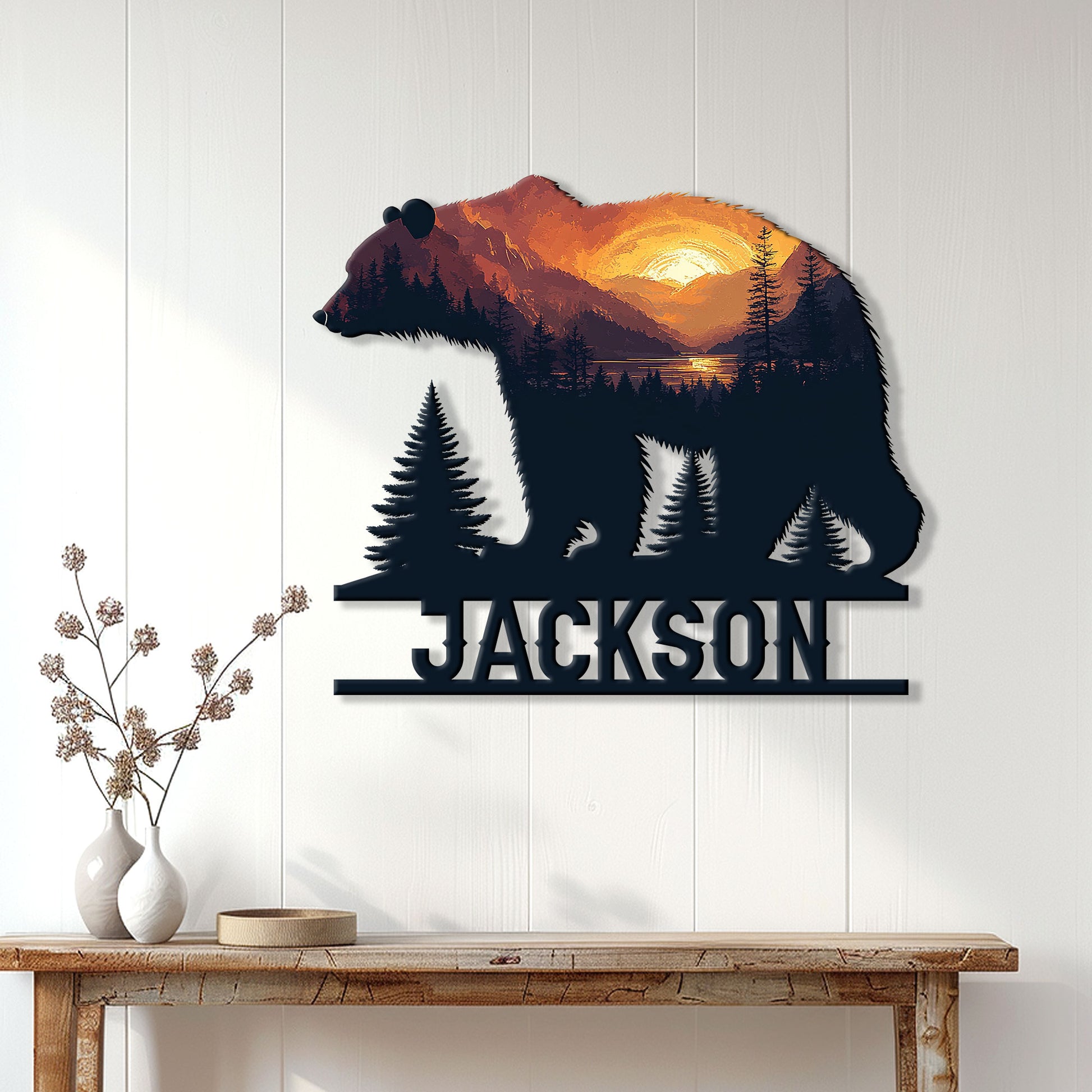 Bear metal wall sign displayed on a white paneled wall above a console table