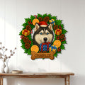 Husky holiday wall sign displayed on a white paneled wall above a console table