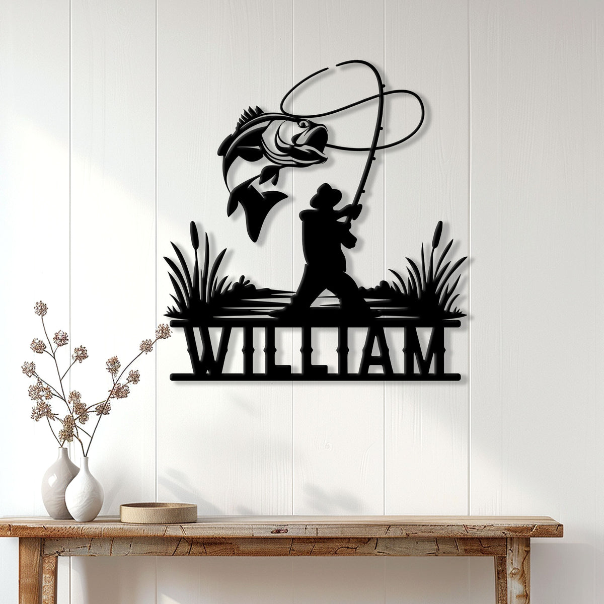 Bass fishing wall decor displayed above a console table, featuring an angler and leaping bass silhouette