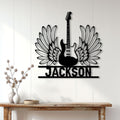 Winged guitar metal sign displayed as statement wall decor above a rustic console table