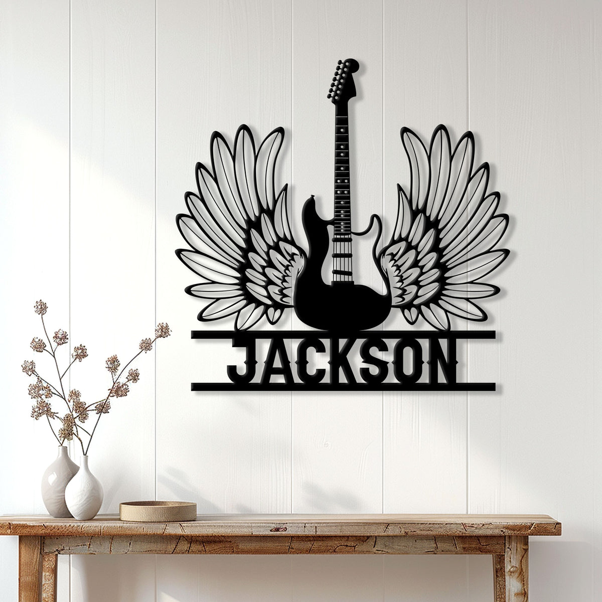 Winged guitar metal sign displayed as statement wall decor above a rustic console table