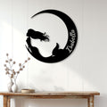 Black mermaid metal wall sign displayed on a white paneled wall above a console table