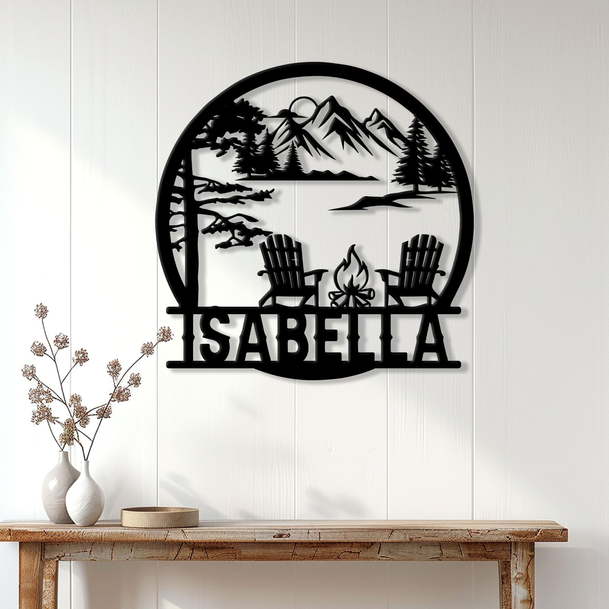 Mountain camping wall decor displayed on a light wood wall above a console table