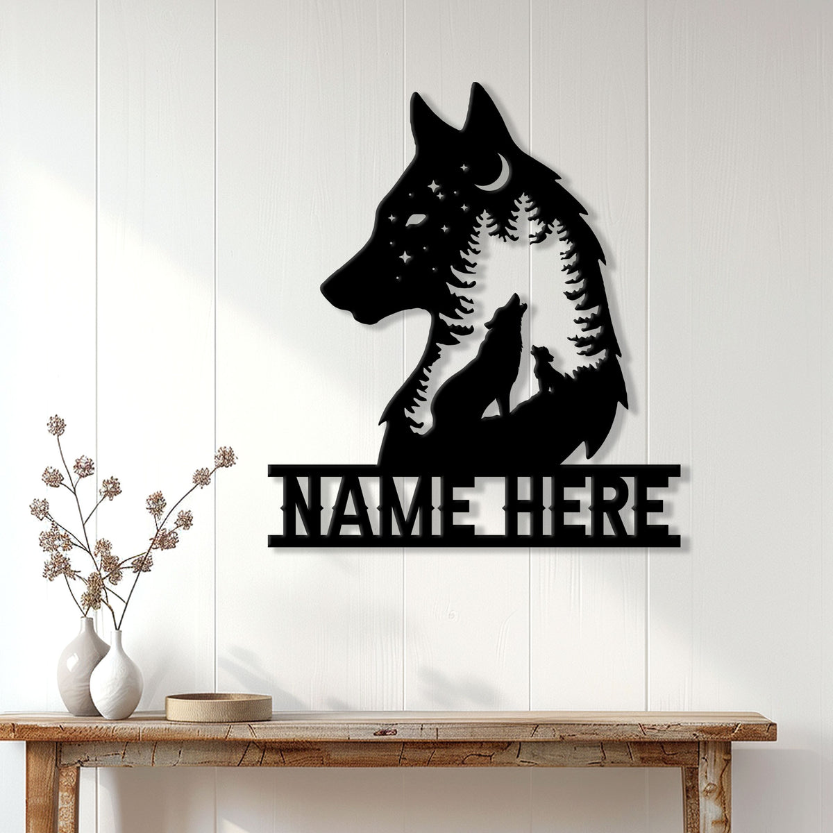 Wolf silhouette metal wall sign displayed on a white paneled wall above a rustic console table