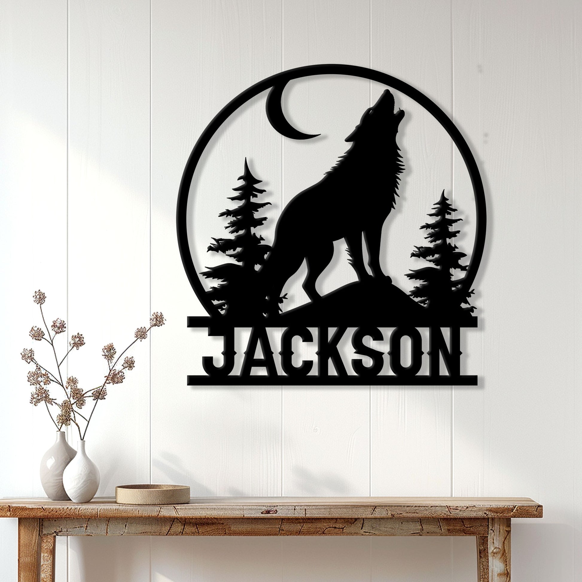 Howling wolf metal wall sign displayed above a console table in a bright home interior