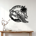 Sea turtle metal wall decor displayed on a light paneled wall above a console table