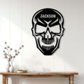 Black and white skull metal wall sign displayed on a white paneled wall above a console table