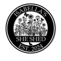 Custom She Shed metal sign with a black-and-white wildflower garden, butterflies, and circular border