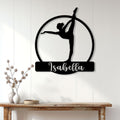 Black gymnast silhouette metal wall sign displayed on a bright paneled wall