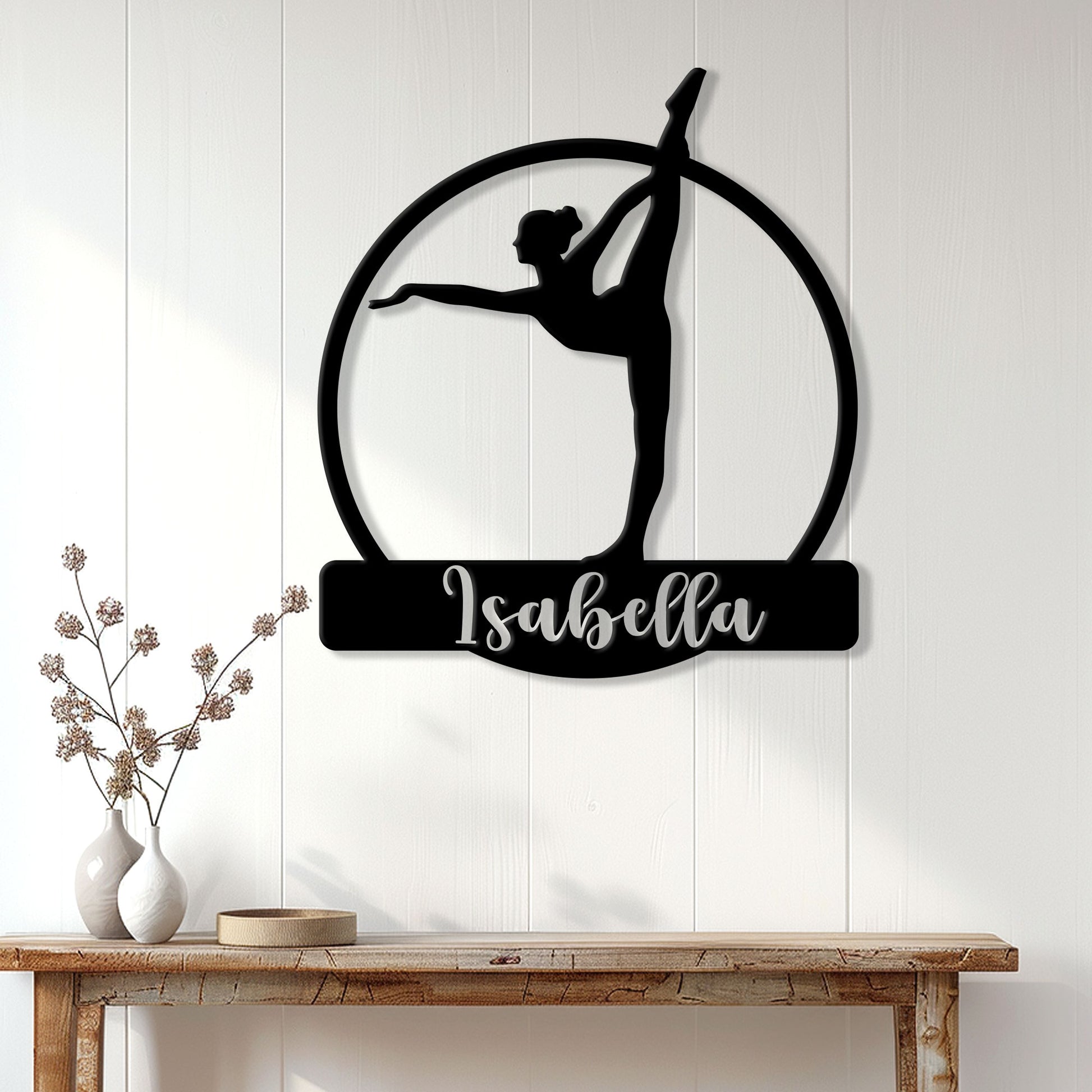 Black gymnast silhouette metal wall sign displayed on a bright paneled wall