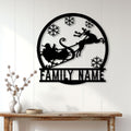 Custom Christmas family metal sign displayed on a white paneled wall above a rustic console table