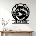Custom raccoon wall sign displayed on a white paneled wall above a rustic console table