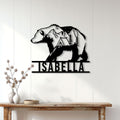 Black bear camping sign displayed as rustic wall decor above a console table in a bright home
