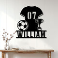 Soccer player metal sign displayed on a light paneled wall above a console table