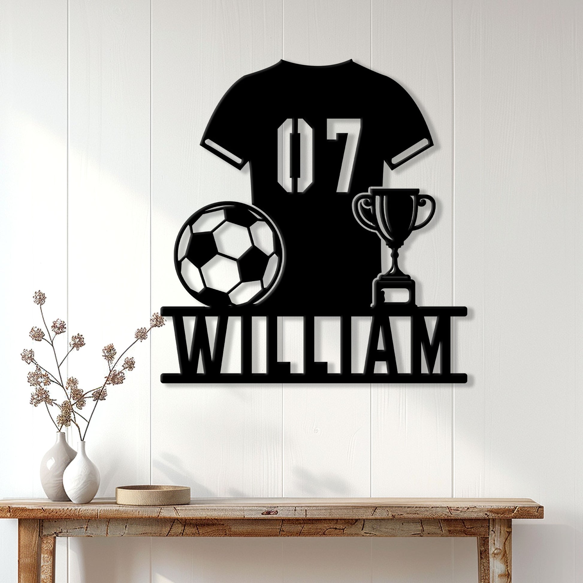Soccer player metal sign displayed on a light paneled wall above a console table
