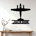 Black airplane pilot metal sign displayed on a bright paneled wall above a console table