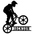 Black silhouette of a freestyle BMX rider on a bike with a bold custom design beneath