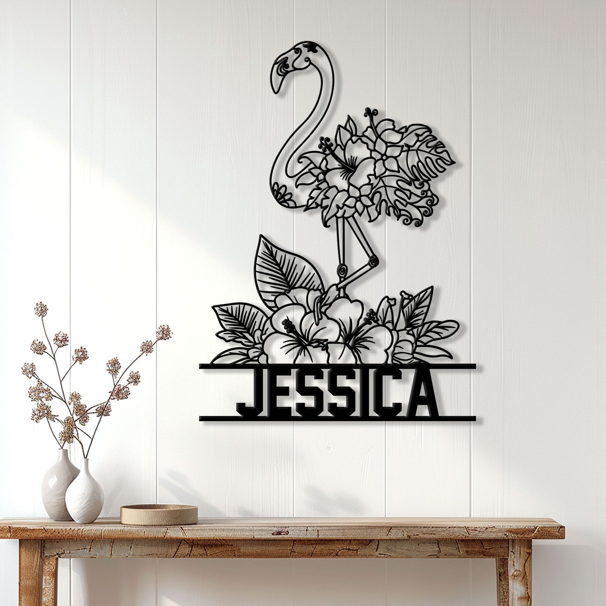 Flamingo floral metal wall art displayed on a white paneled wall above a wood console table