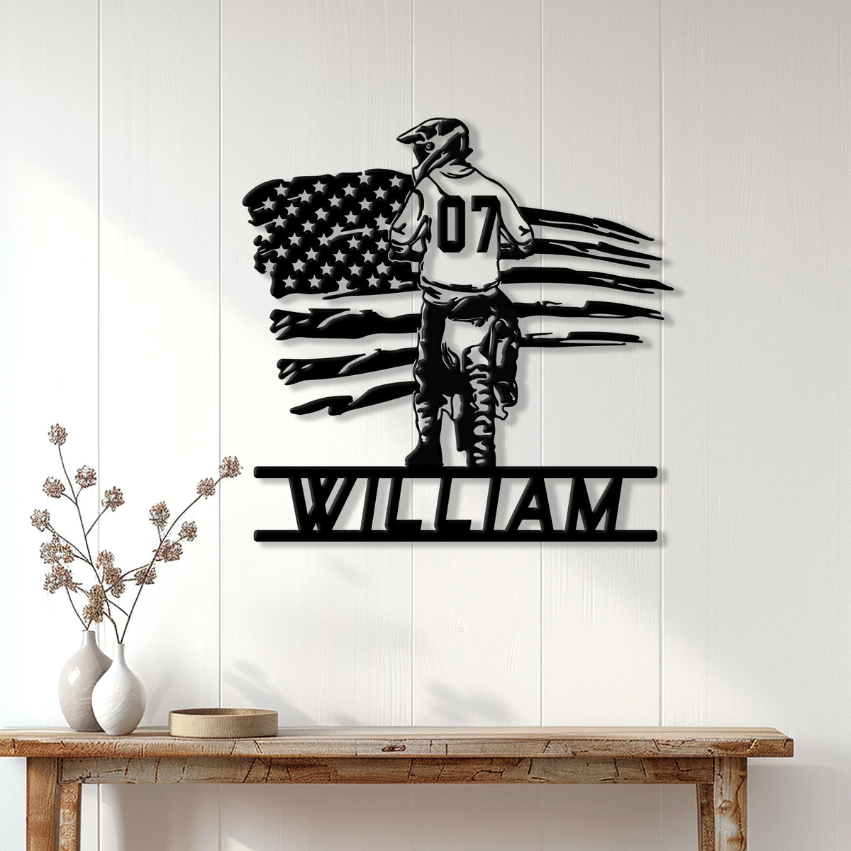 Motocross metal wall sign displayed on a bright paneled wall above a rustic console table