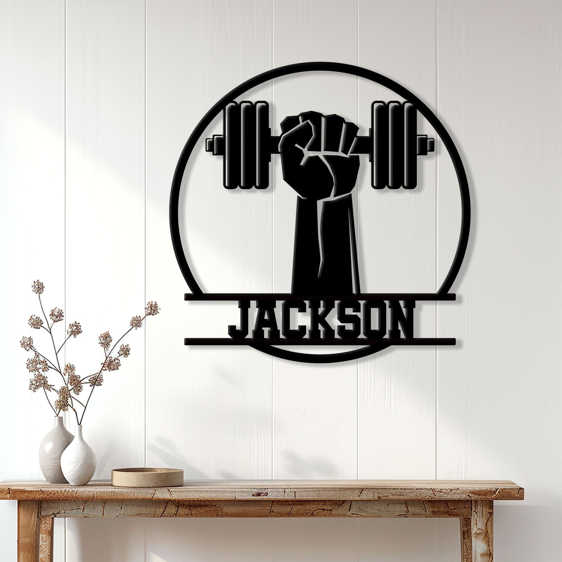 Black weightlifting metal sign displayed on a white wall above a console table