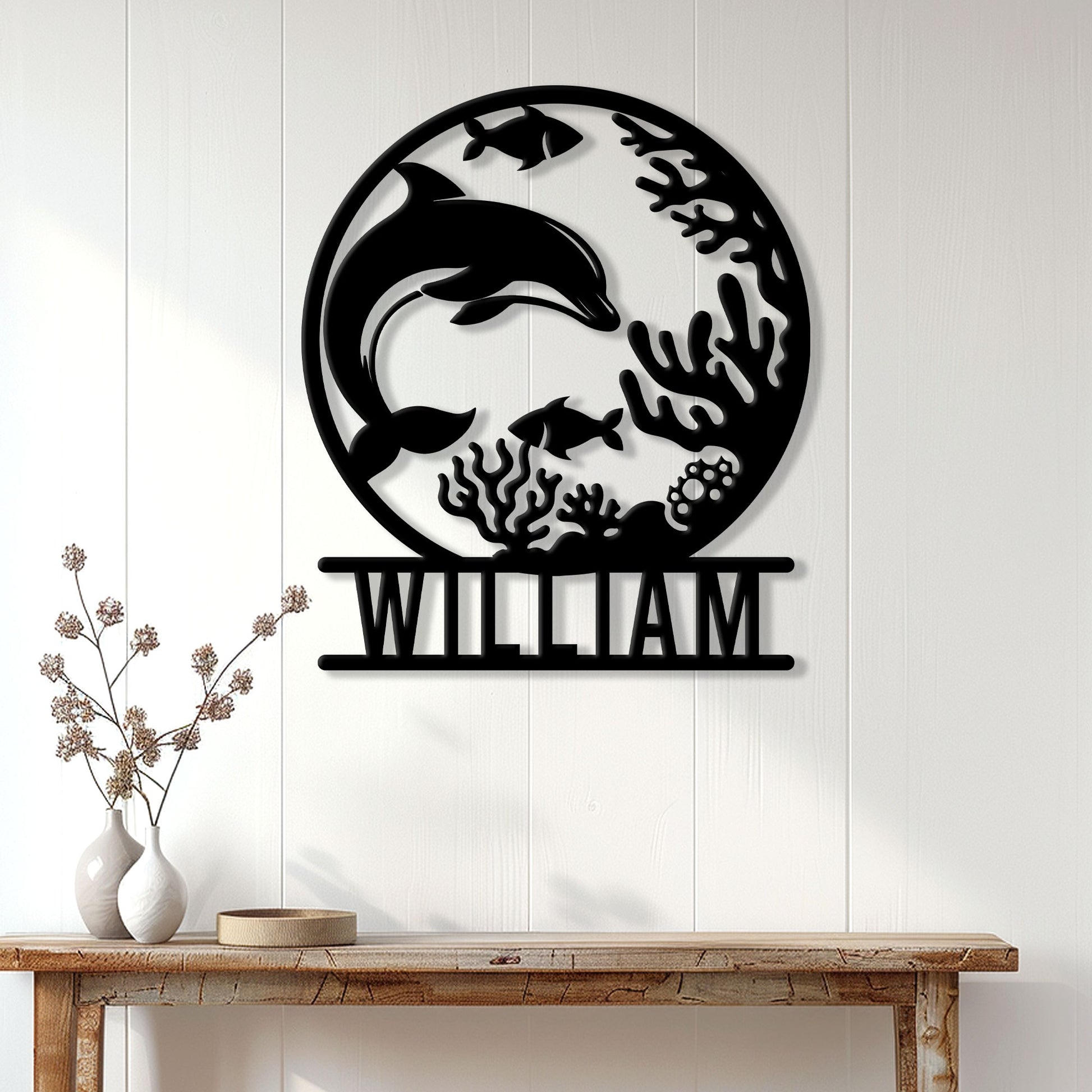 Dolphin metal wall decor displayed on a white paneled wall above a console table