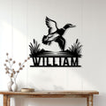 Duck hunting metal wall sign displayed on a light paneled wall above a wood console