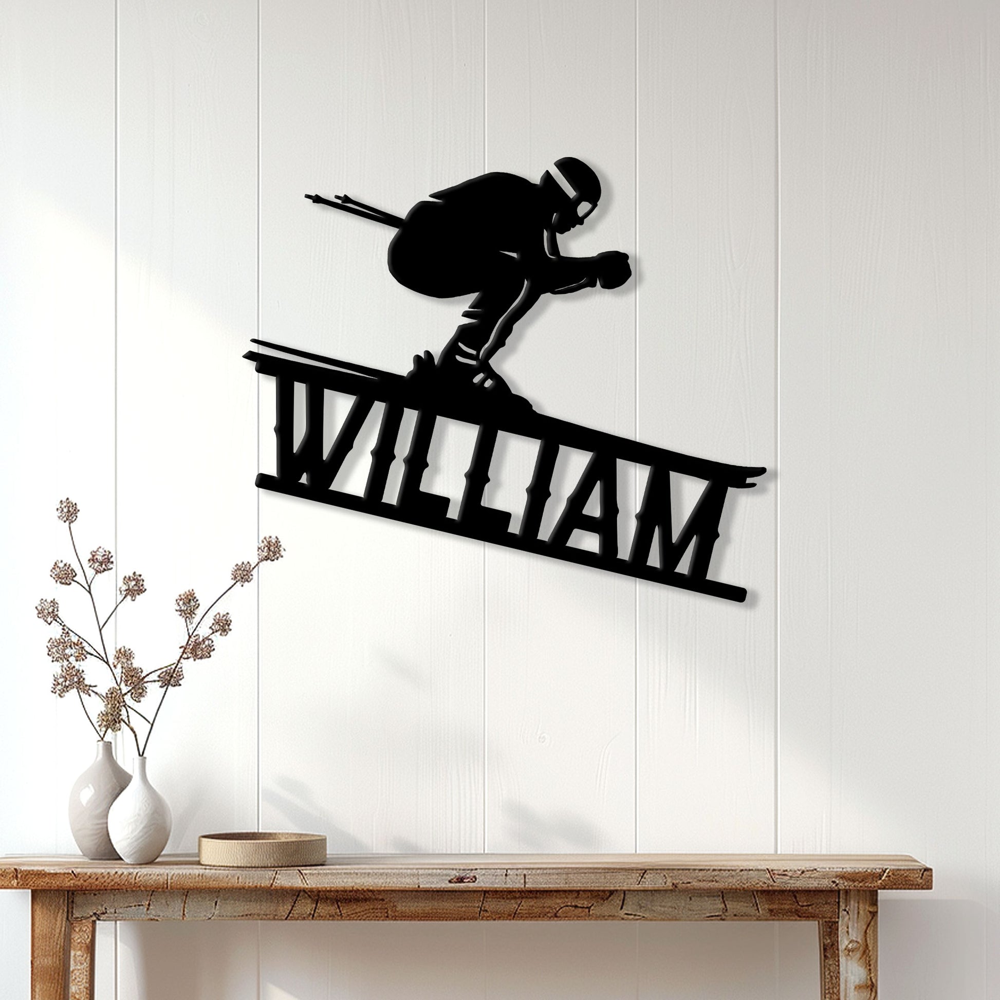 Black skier silhouette metal sign displayed as skiing wall decor above a wood console