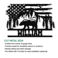 Cut metal bear sign featuring a patriotic flag design, evergreen trees, mountains, and wildlife silhouette