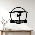 Gymnastics wall decor displayed on a white paneled wall above a console table in a bright home
