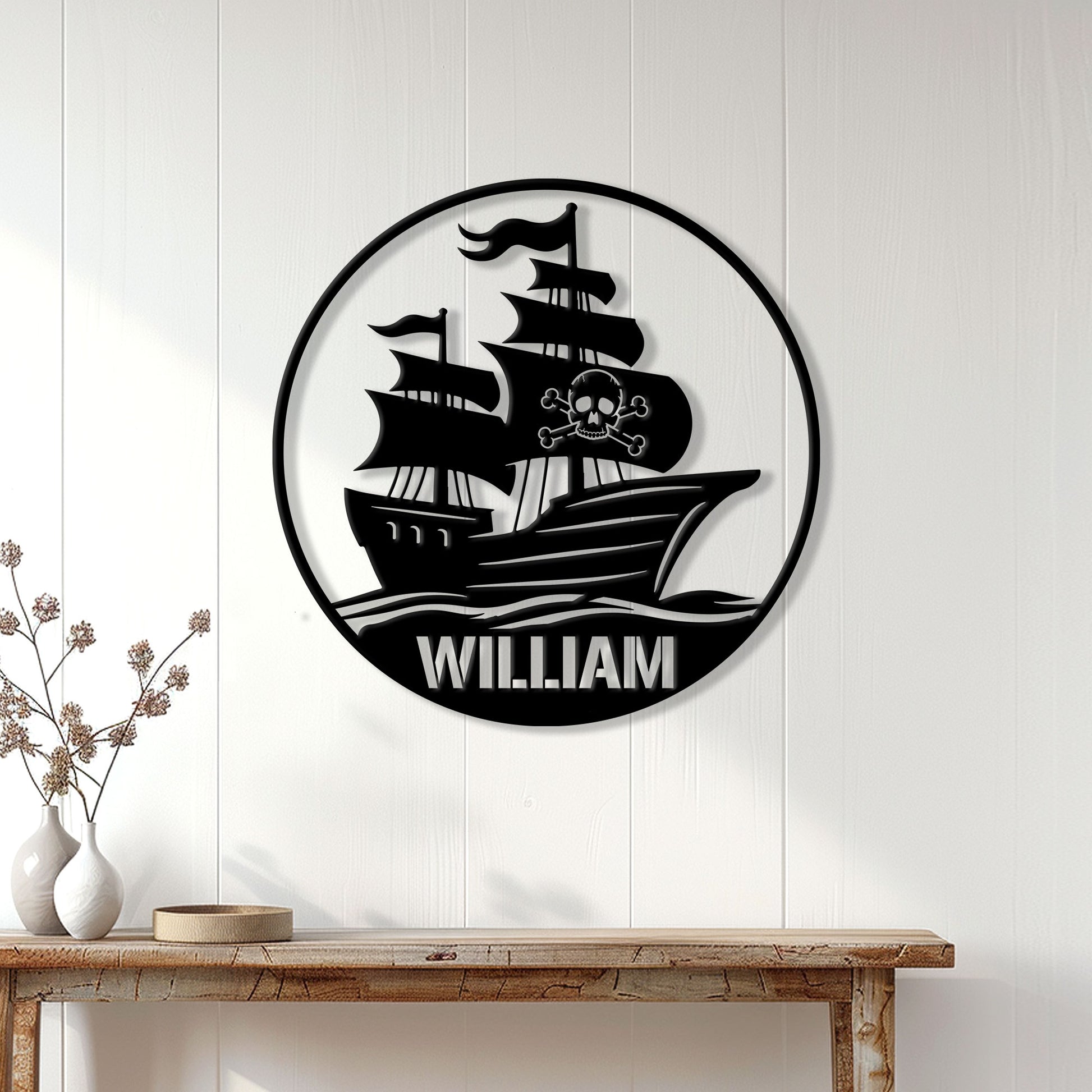 Pirate ship metal wall decor displayed on a white paneled wall in a home setting