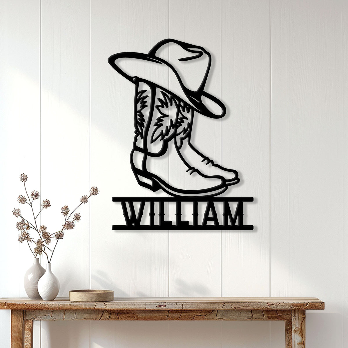 Cowboy boot wall sign displayed on a white paneled wall above a rustic console table