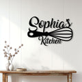 Black kitchen scissors wall sign displayed on white paneling above a rustic console table